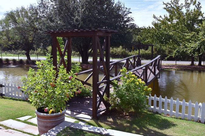 "Bridge Leads to Shaded Deck Over The Water"