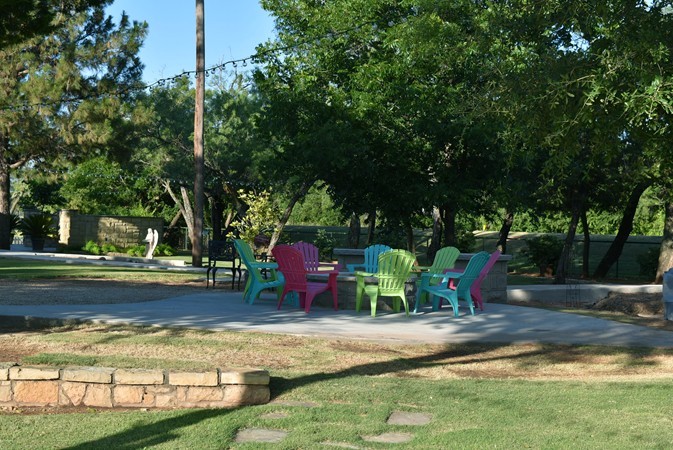 "Relazing View Of Trees & Angel Around Gas Fire Pit"