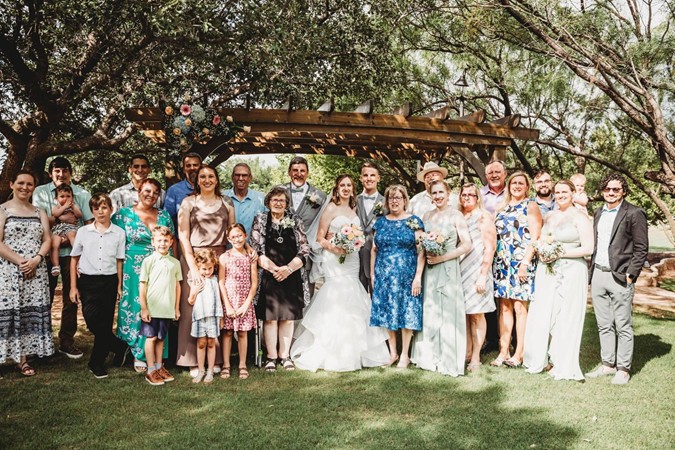 "Pergola & Trees Provide Lovely Background for Group Photo"
