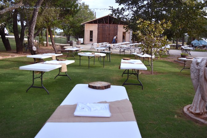 "New Tablecloth, Burlap Runner, And Log Slice Placed On Each Table"