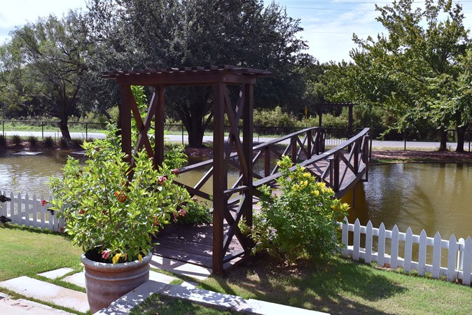 "Bridge Leads to Shaded Deck Over The Water"