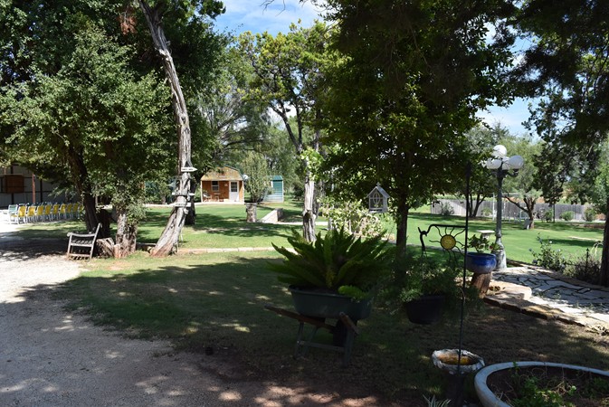 "Pavilion Beyond Bench and Sign Post"